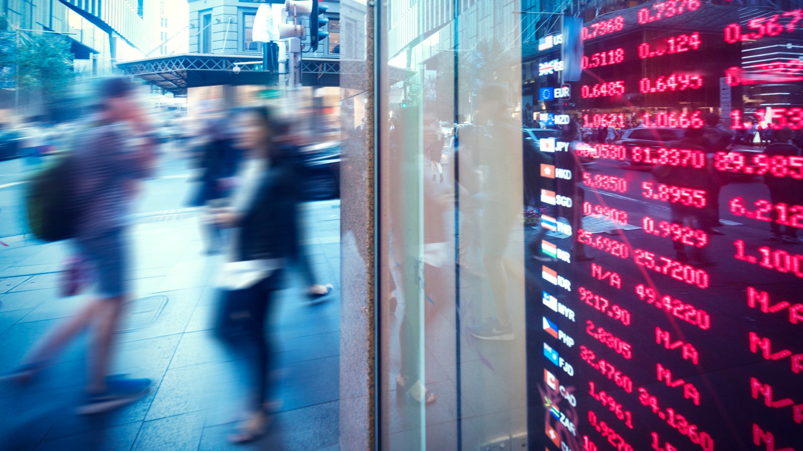 Global financial exchange rates displayed in a bank window.