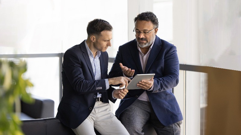The MFSA provides new guidance on safeguarding arrangements, professional men on tablet discussing